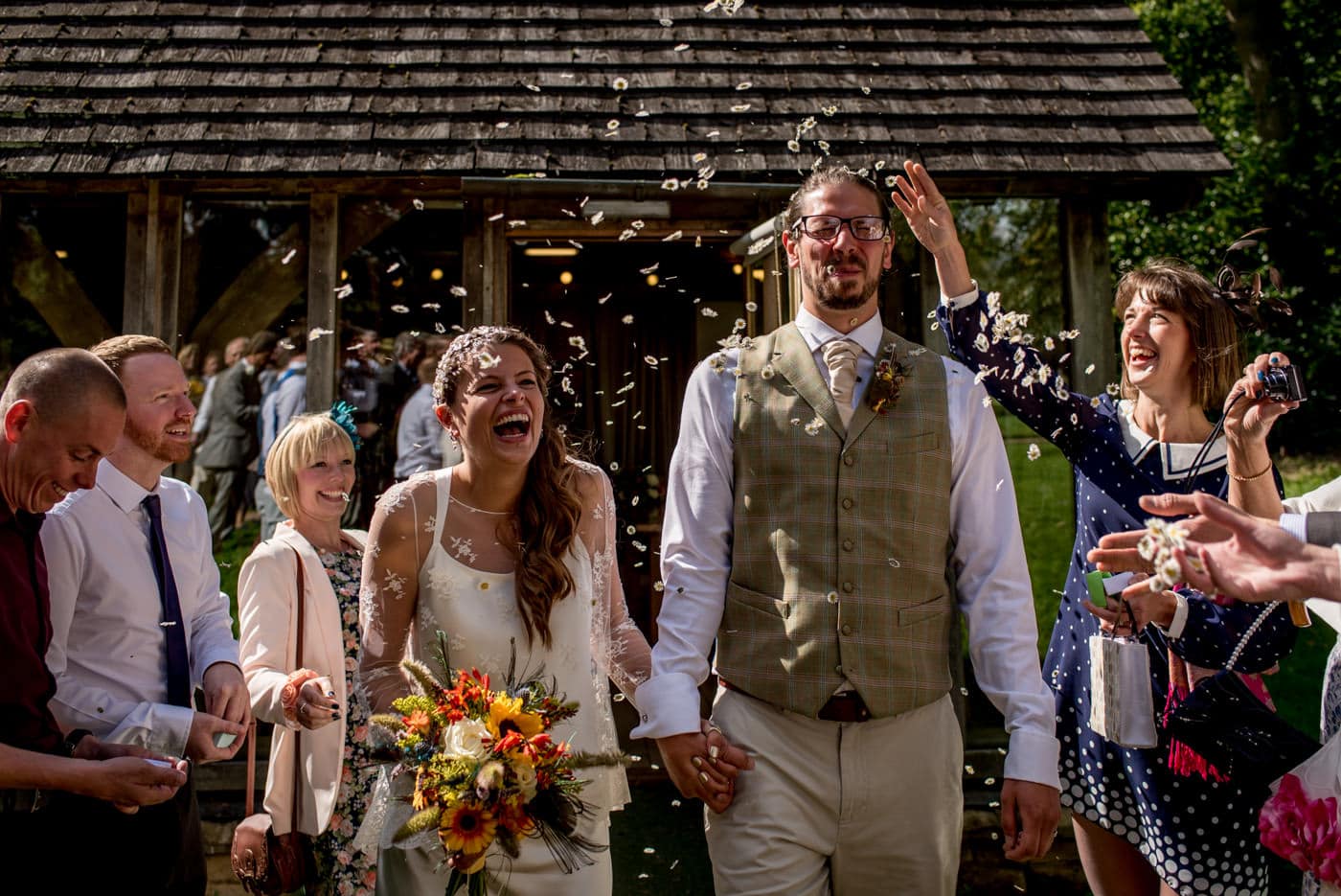 Featured on the Rock n Roll Bride Wedding Blog - bride and groom having confetti thrown at them
