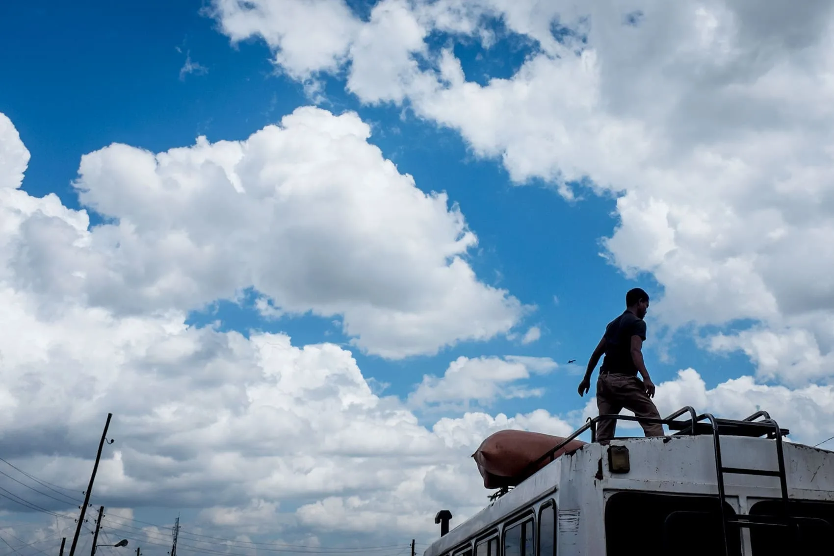 Loading the roof of a mini bus in Addis Ababa, Ethiopian street photography