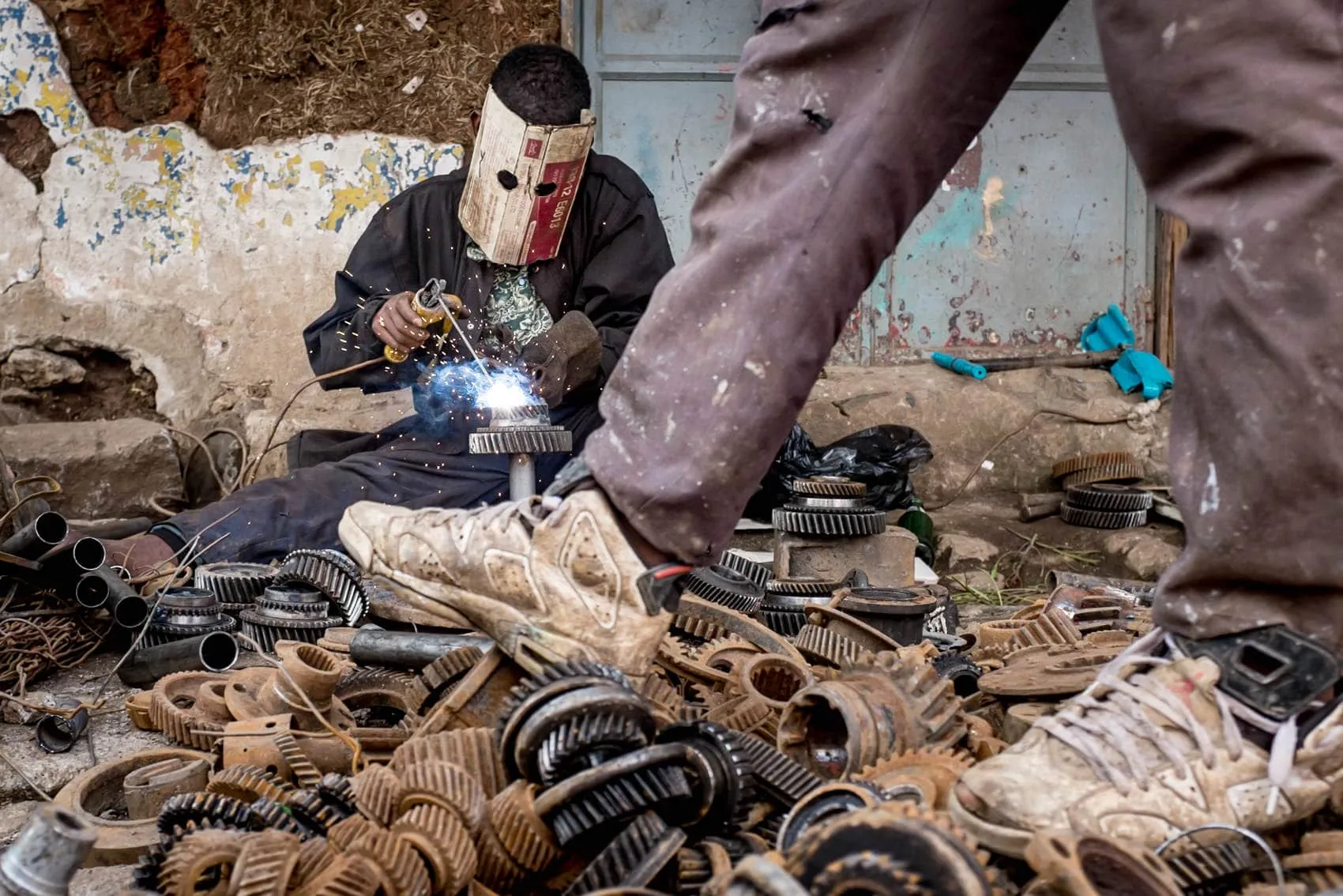 A street photographer capturing welding in the street in Addis Ababa, Ethiopia
