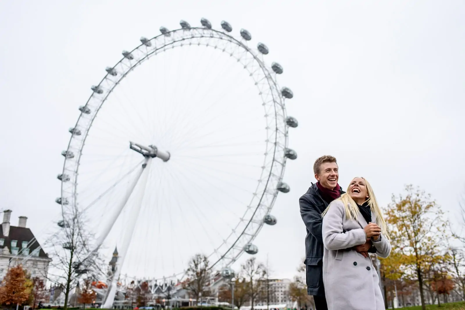 Photo of couple laughing during their London Eye engagement photography shoot in London