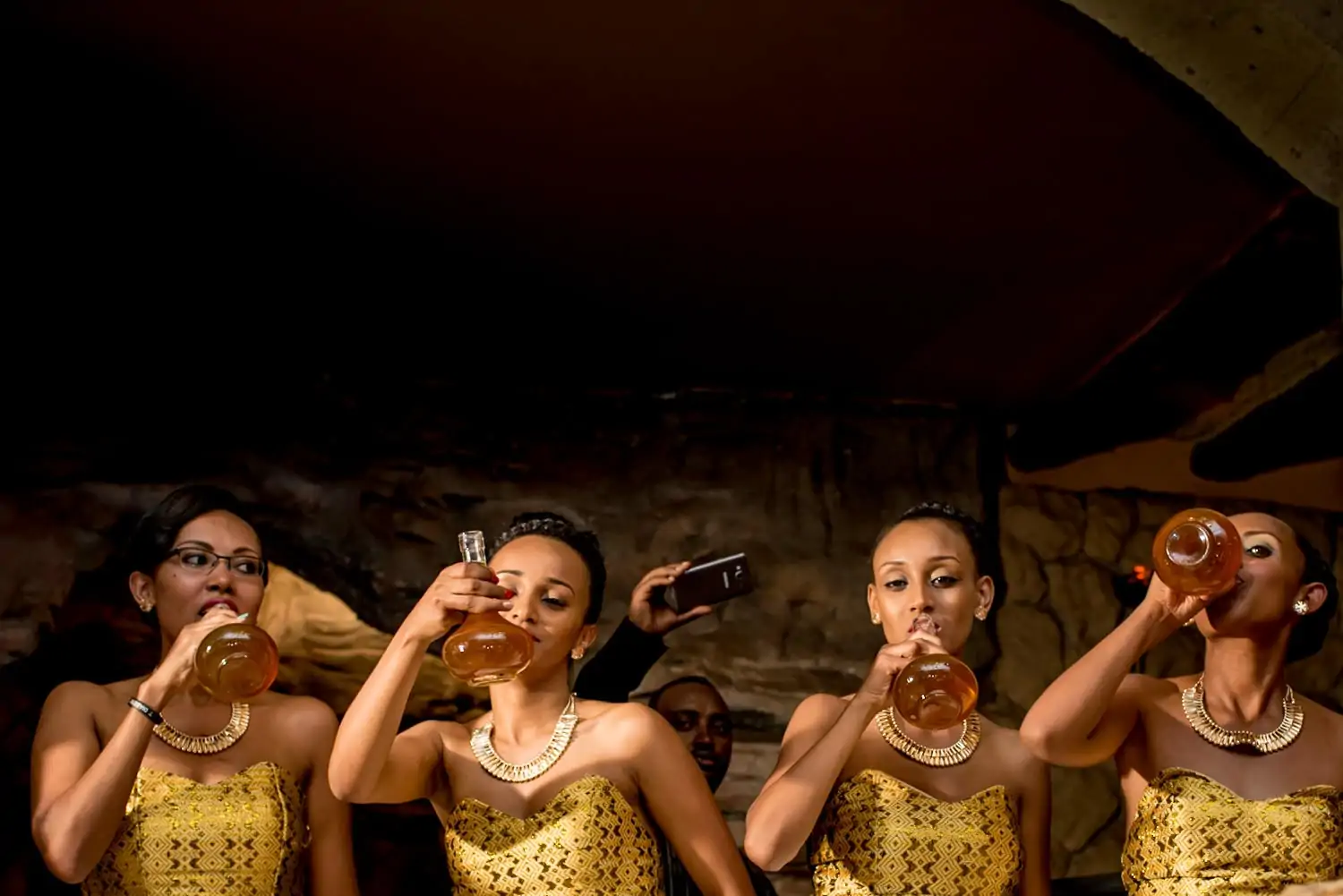 Ethiopian bridesmaids drinking honey wine at the wedding