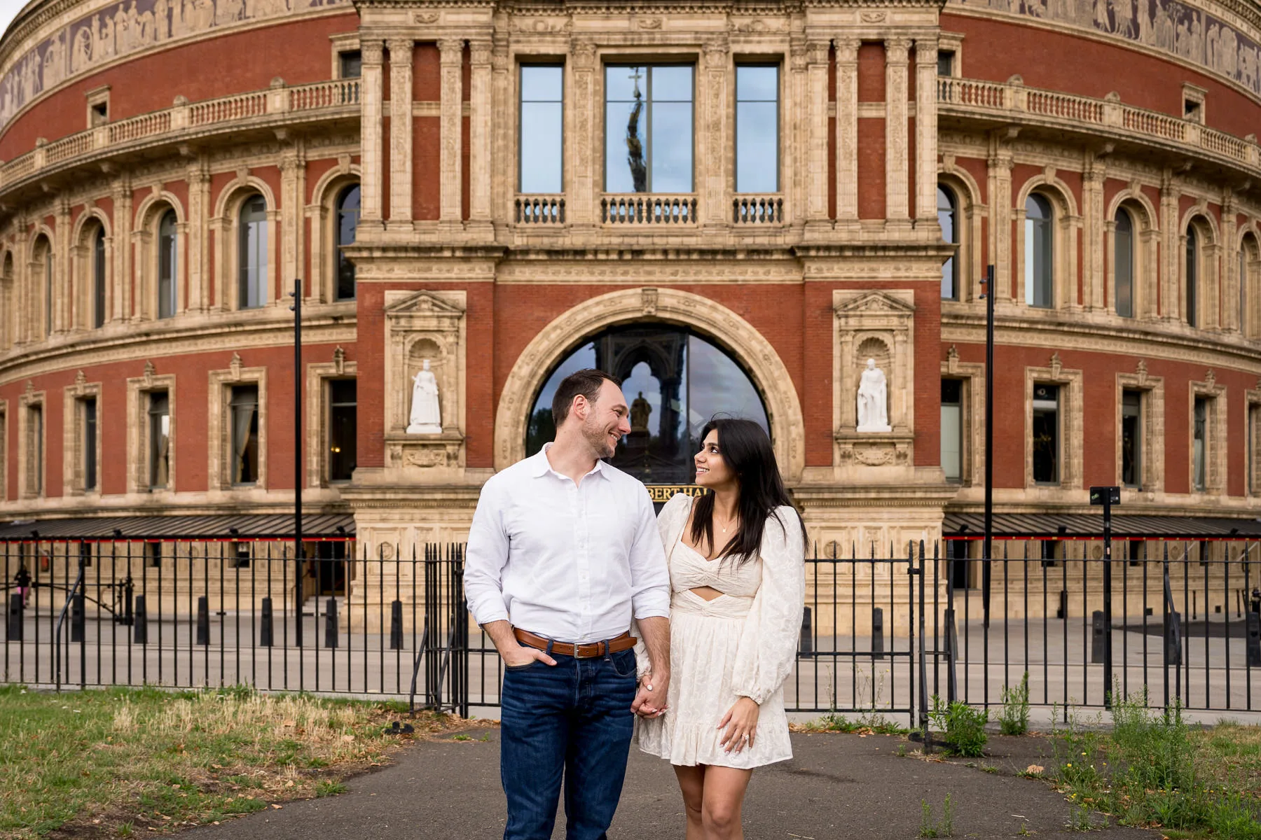 A couple who just got engaged with Royal Albert Hall in the background