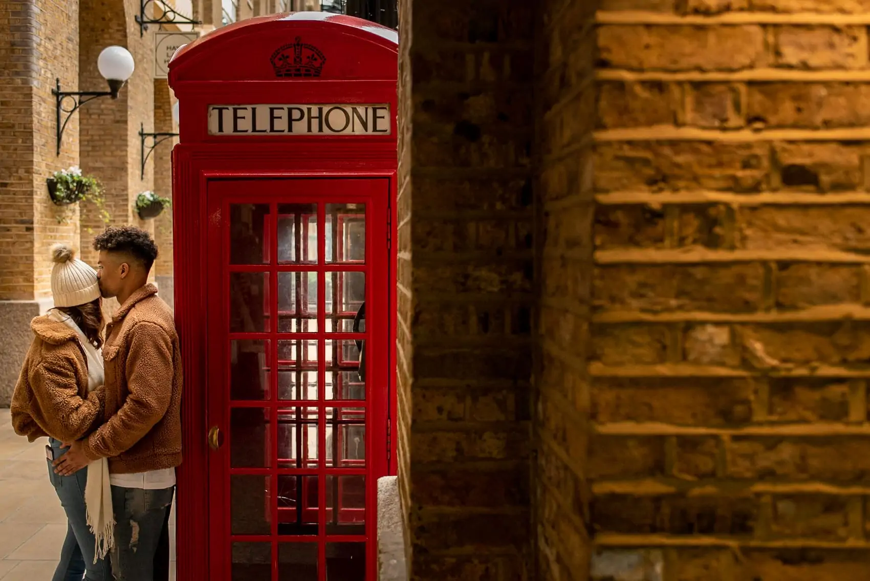Couple kissing next to a London Red telephone box