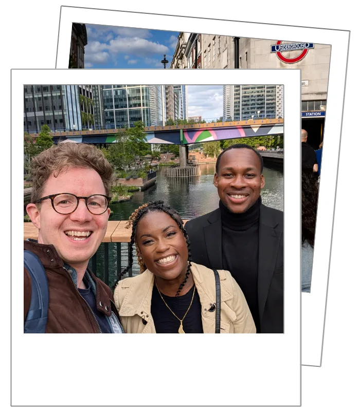 Proposal Photographer Matt Badenoch laughing with a couple at the end of their engagement shoot in Canary Wharf, London