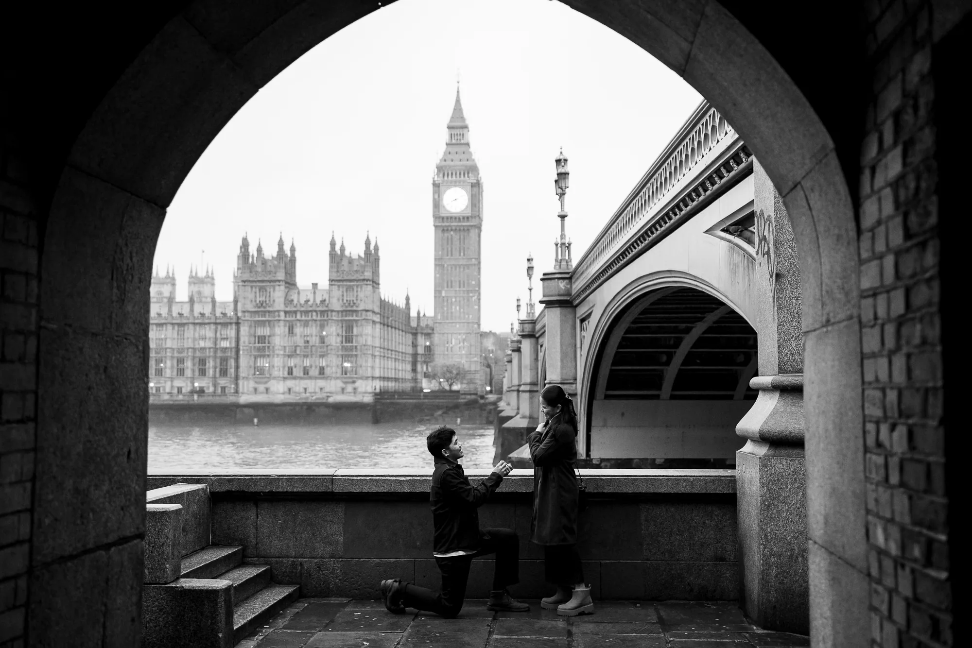 a man proposes to his girlfriend in front of Big Ben on a winters mornings