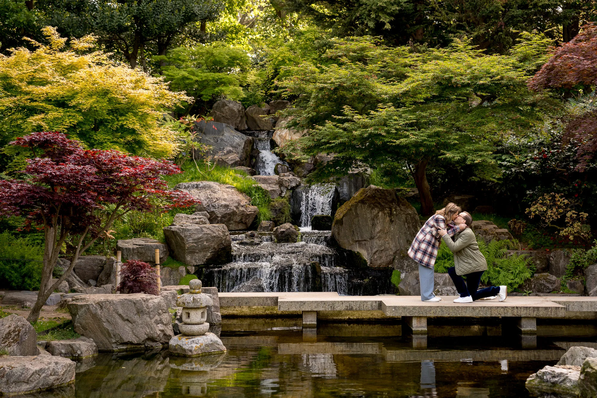 man on one knee proposing to his girlfriend in Kyoto garden