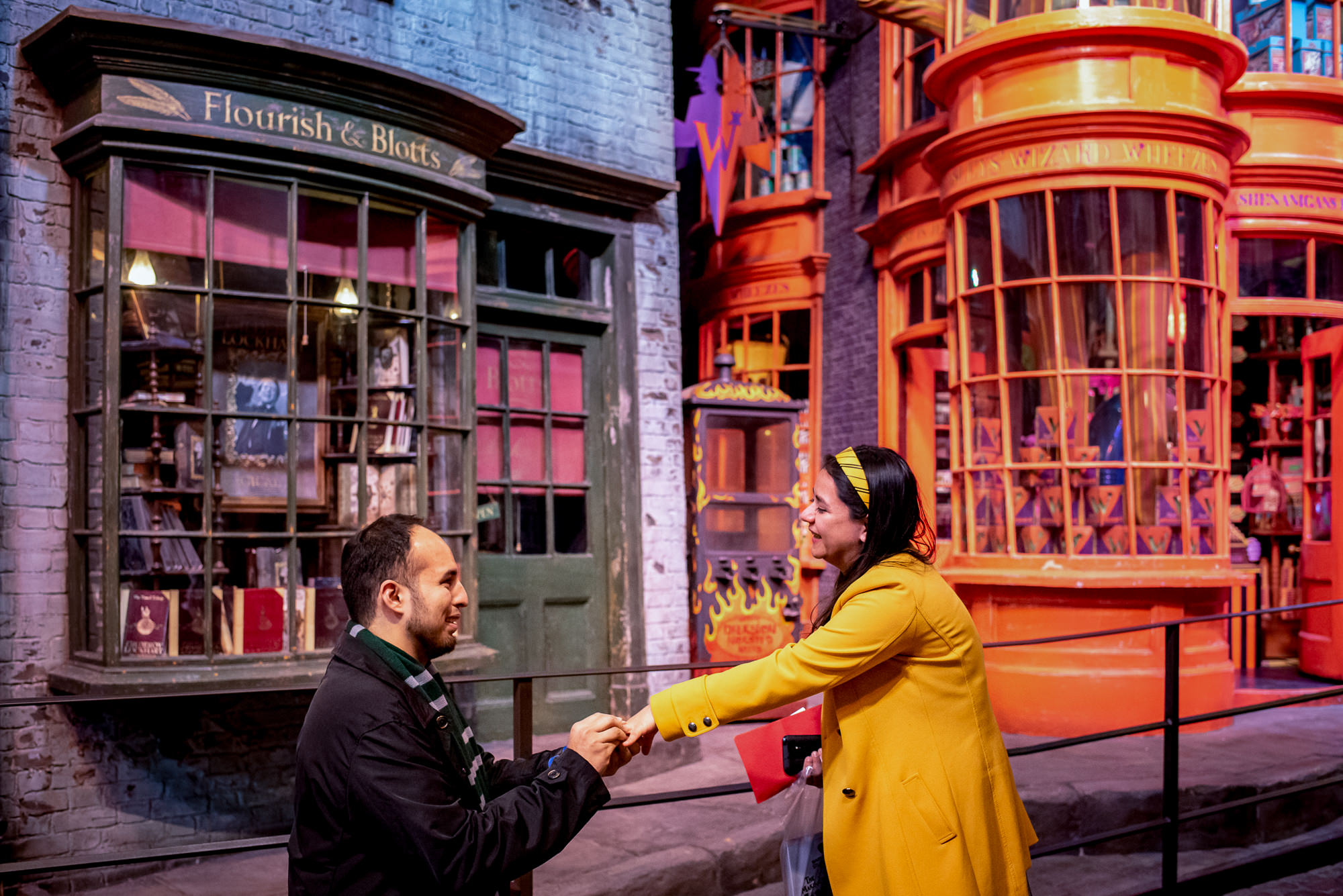 a couple get engaged in Diagon Alley at the Harry Potter studios in London