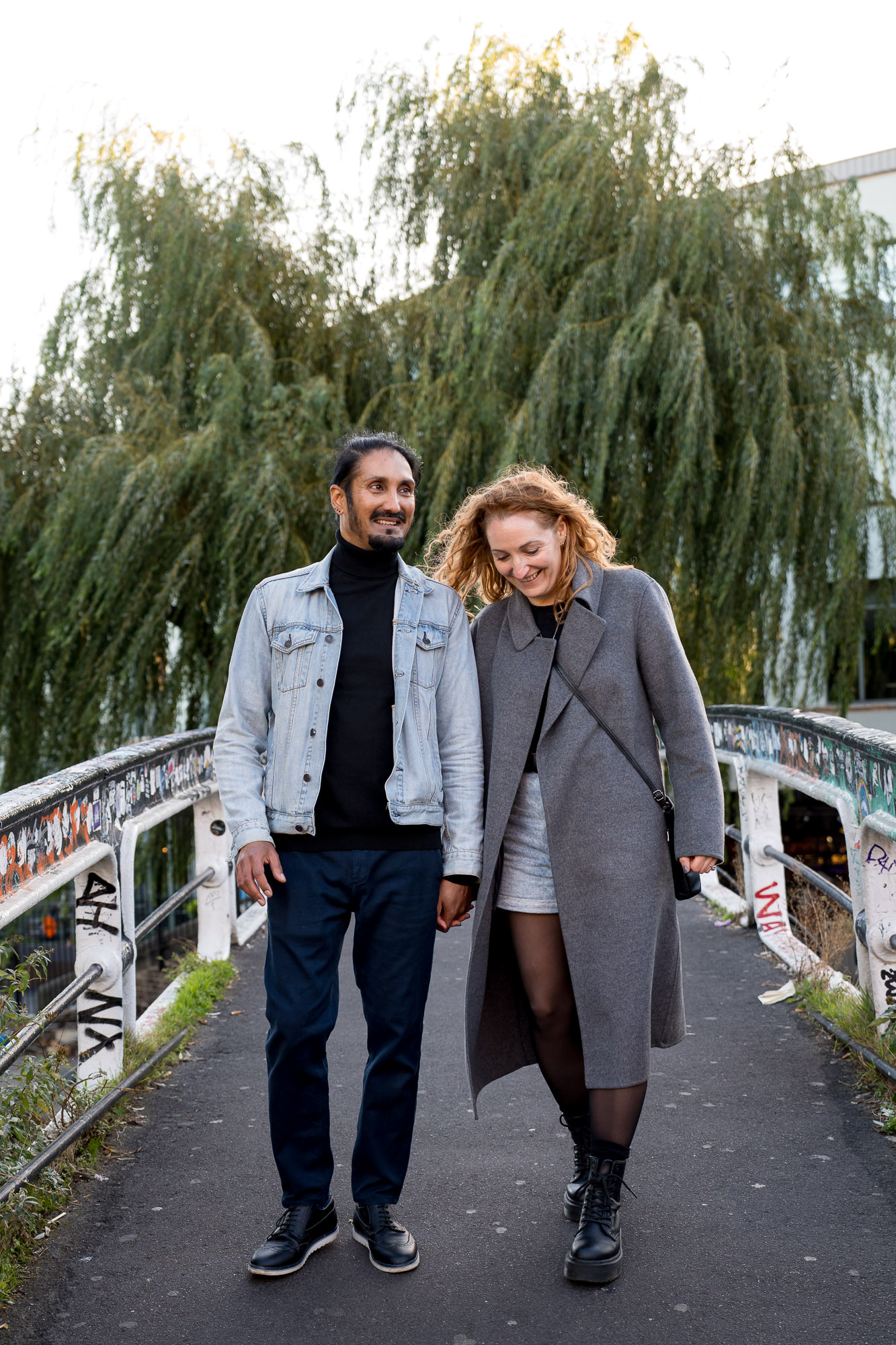 A couple walking on a bridge over the Camden canal
