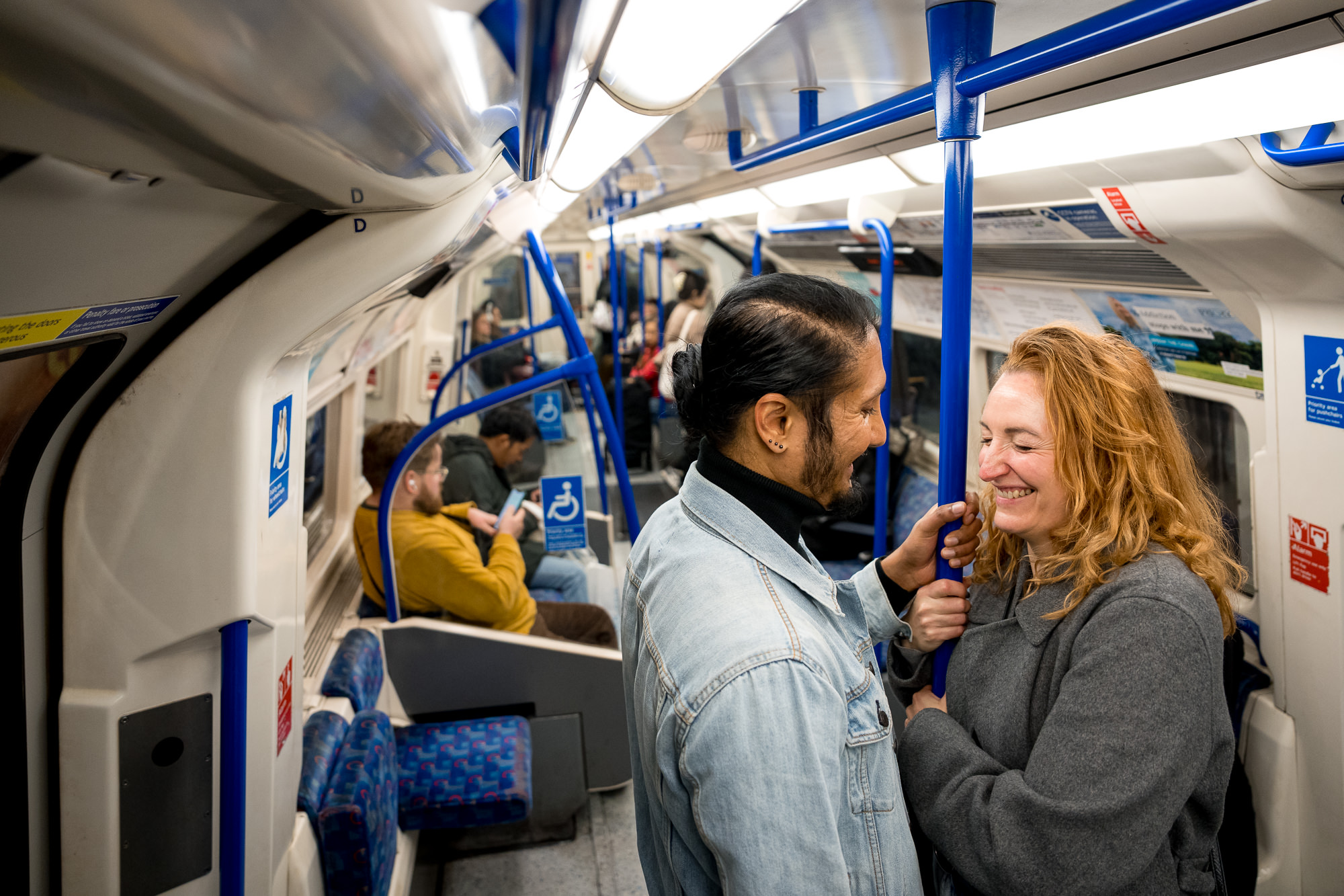 A couple laughing together on the London underground