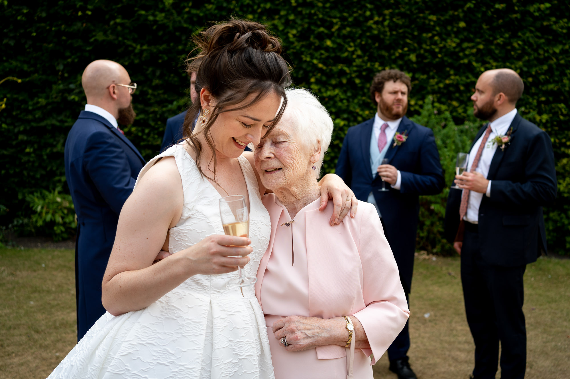 bride hugging her grandmother in the garden of a micro wedding in london