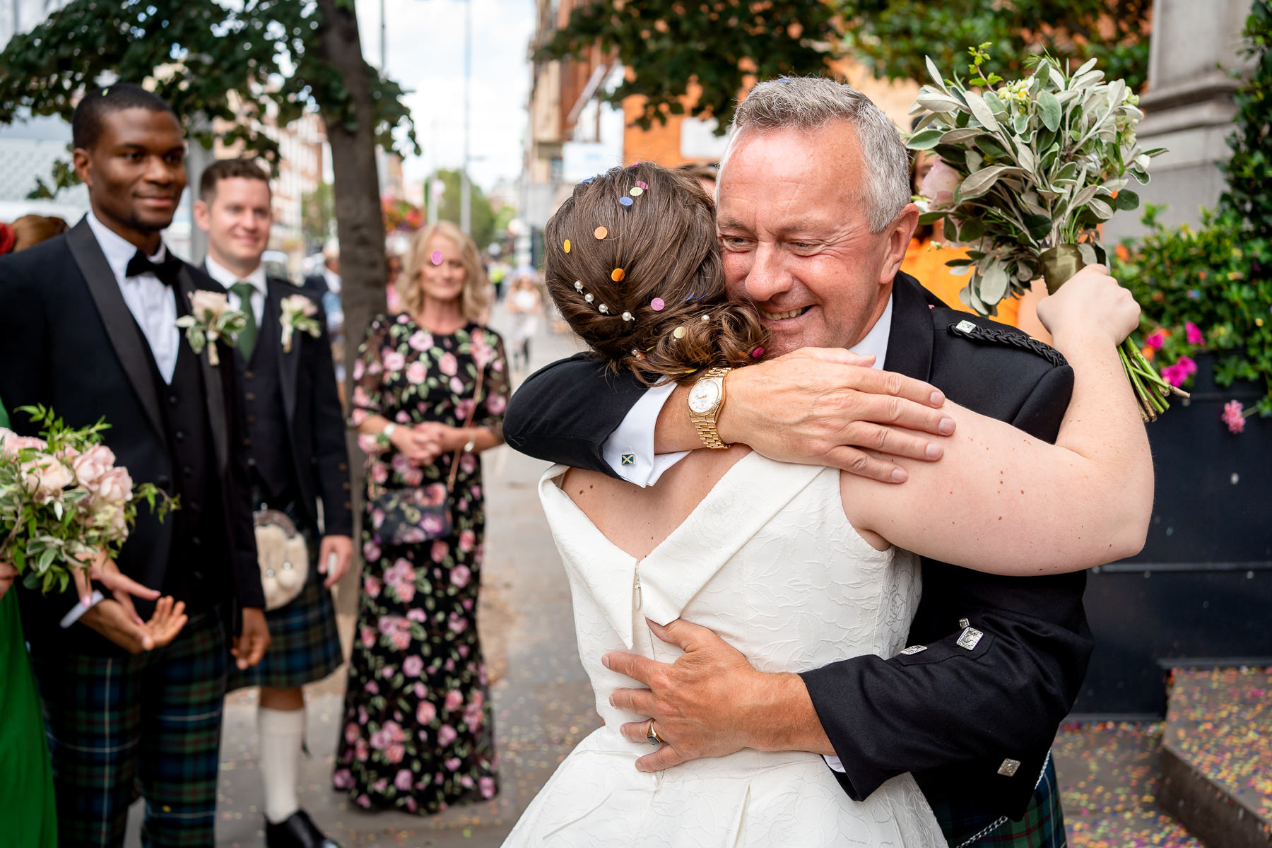 A dad hugging his daughter outside of Chelsea Old Town Hall after she just got married in London